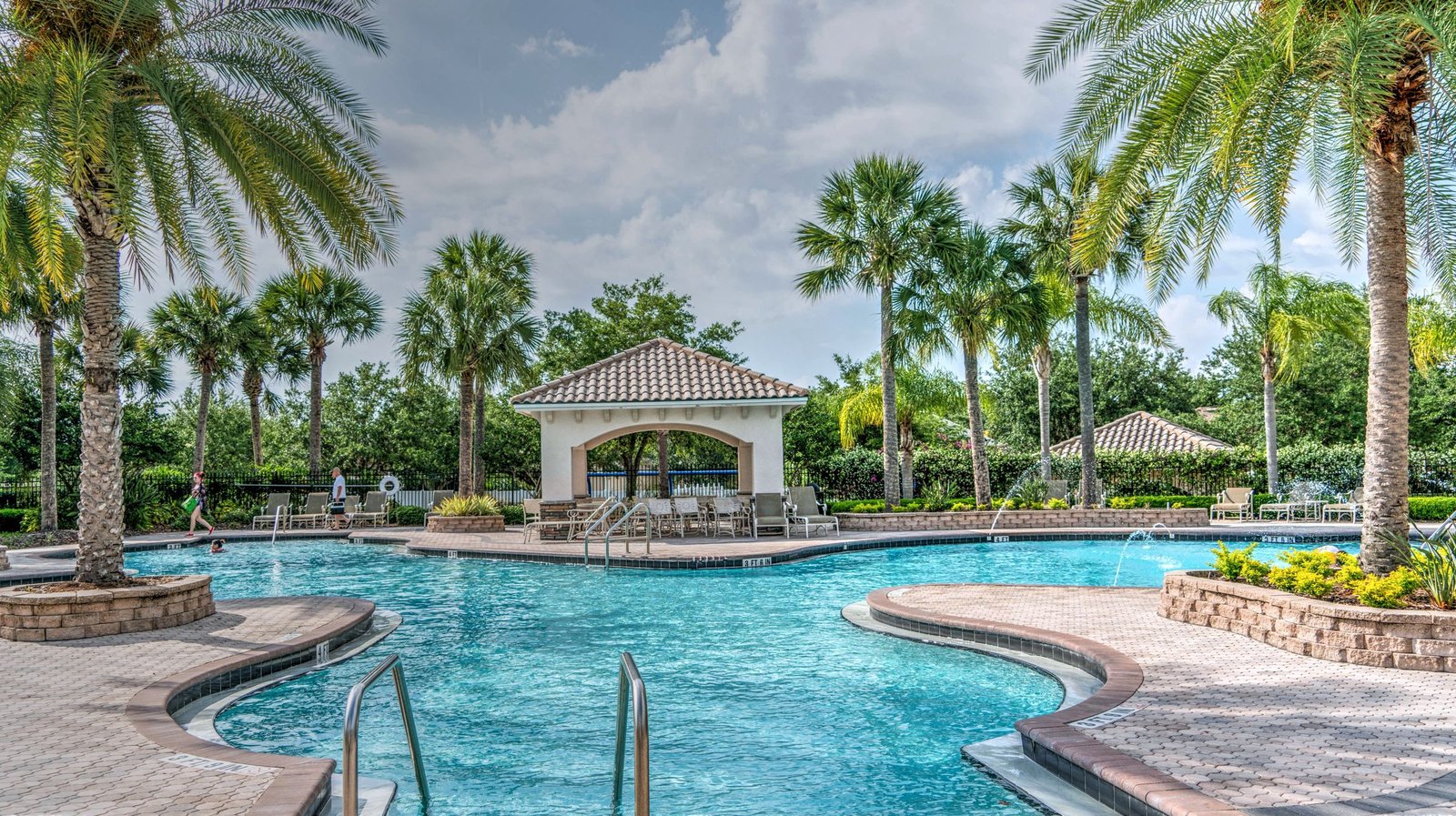 The resort-style pool at Breckenridge Court, framed by palms and mature landscaping